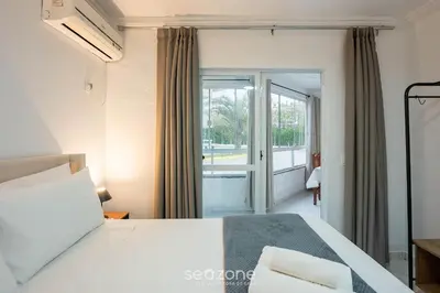 Uma cama ou camas num quarto em Aptos em Condomínio a 40 metros da Praia de Bombinhas - BDSs