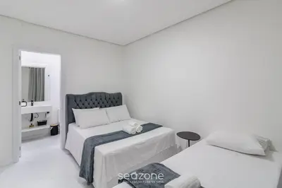 Uma cama ou camas num quarto em Estadia completa a 500m do mar em Itapema - STWs