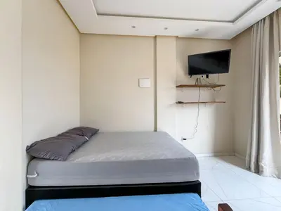 Uma cama ou camas num quarto em LOFT SOL e MAR exclusivo em bombinhas, 50 metros do mar