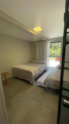 Uma cama ou camas num quarto em Villa Parati Bombinhas