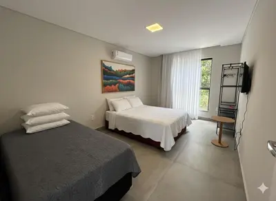 Uma cama ou camas num quarto em Villa Parati Bombinhas