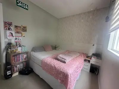 Uma cama ou camas num quarto em Leondina Soares Apartamento 403