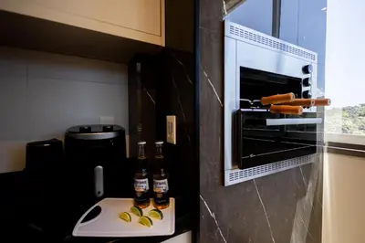 A cozinha ou kitchenette de Loft confortável em condominio com Piscina