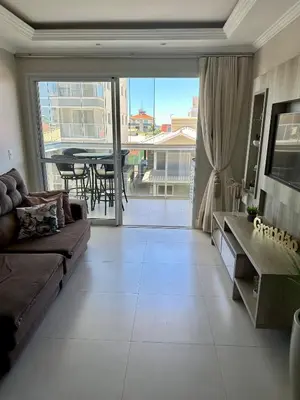 Uma área de estar em Apartamento na praia de Palmas à 200m do mar