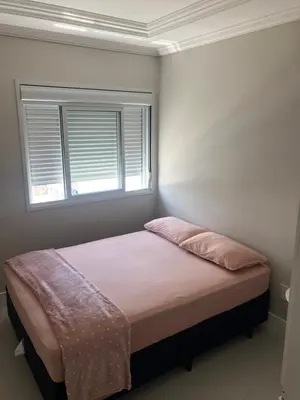 Uma cama ou camas num quarto em Apartamento na praia de Palmas à 200m do mar