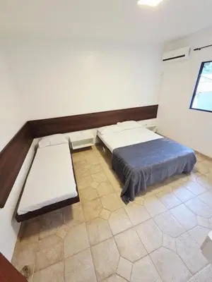 Uma cama ou camas num quarto em Cantinho da costeira