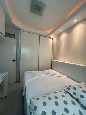 Uma cama ou camas num quarto em Apto Almeida e Moraes 3 Suítes c/churrasqueira Meia Praia
