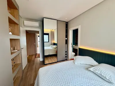 Uma cama ou camas num quarto em Apartamento 3 dormitórios quadra da praia