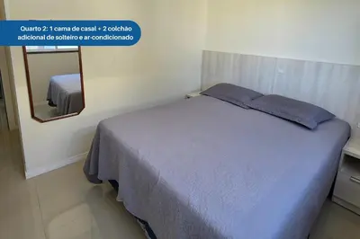 Uma cama ou camas num quarto em Apartamento no Coração de Bombinhas