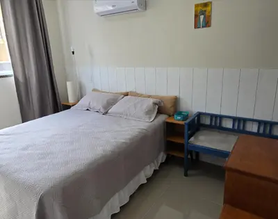 Uma cama ou camas num quarto em Aconchego em Bombinhas com Piscina