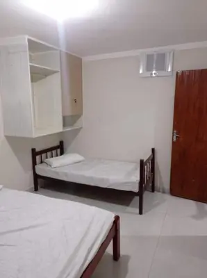 Uma cama ou camas num quarto em Casa de praia em Bombinhas, Santa Catarina