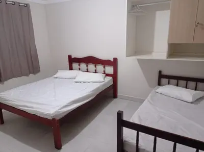 Uma cama ou camas num quarto em Casa de praia em Bombinhas, Santa Catarina