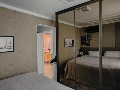 Uma cama ou camas num quarto em coração de Balneário Camboriú