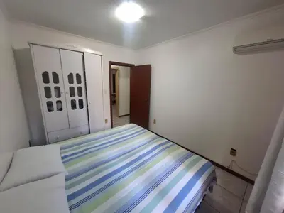 Uma cama ou camas num quarto em Apartamento a Beira Mar em Meia Praia