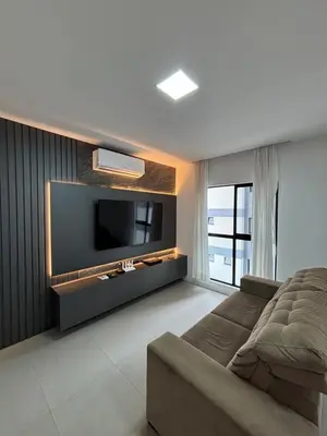 Uma televisão e/ou sistema de entretenimento em Apartamento lindo e super confortável em itapema