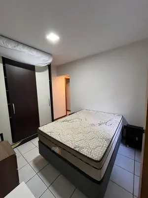 Uma cama ou camas num quarto em Aparatamento 3 dormitorios em Meia Praia - Itapema