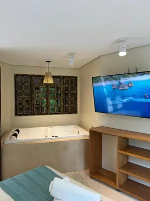 Uma cama ou camas num quarto em Studio Com Hidro e Cromoterapia Baoba Suites