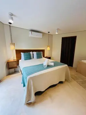 Uma cama ou camas num quarto em Studio Com Hidro e Cromoterapia Baoba Suites