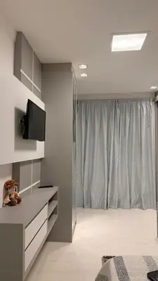 Uma televisão e/ou sistema de entretenimento em Apartamento luxo Praia Meia Praia