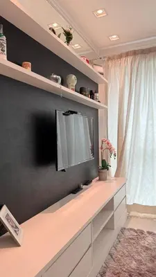 Uma televisão e/ou sistema de entretenimento em Apartamento luxo Praia Meia Praia