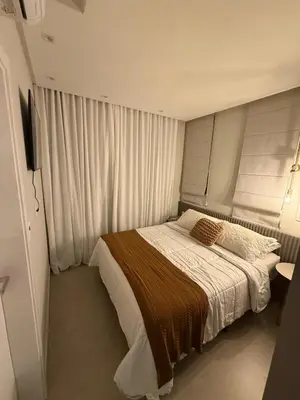 Uma cama ou camas num quarto em Apartamento Flat Elegance Bombinhas