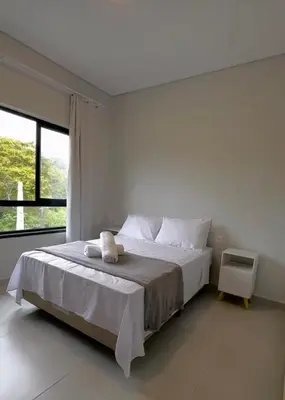 Uma cama ou camas num quarto em Casa com 3 quartos em Bombinhas