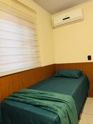 Uma cama ou camas num quarto em Casa pertinho da Praia Central de Itapema