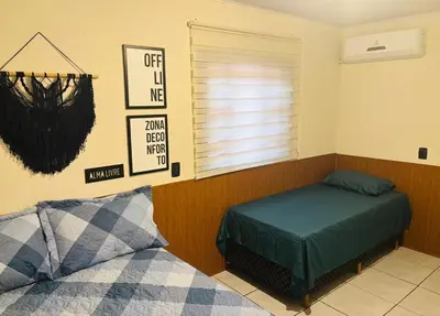 Uma cama ou camas num quarto em Casa pertinho da Praia Central de Itapema