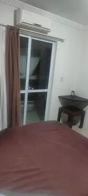 Uma cama ou camas num quarto em Suíte na rua da praia