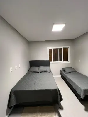 Uma cama ou camas num quarto em Casa de Praia Palmas GCR SC