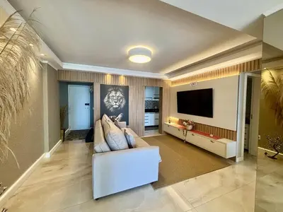 Uma televisão e/ou sistema de entretenimento em Lindo apartamento a 50 Metros da praia de Balneário Camboriú, com vista mar