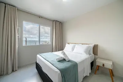 Uma cama ou camas num quarto em Achei Itapema • Res. Adriana Bombas, Bombinhas