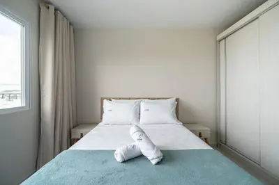 Uma cama ou camas num quarto em Achei Itapema • Res. Adriana Bombas, Bombinhas