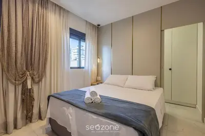 Uma cama ou camas num quarto em Apto c/ varanda gourmet a 700m da Praia BON1101