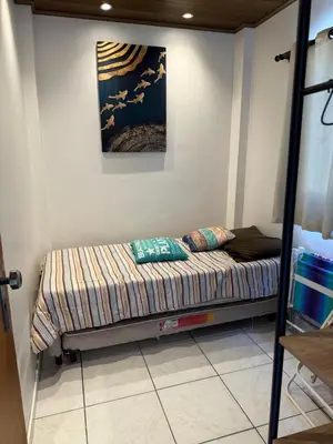 Uma cama ou camas num quarto em Cobertura a 130 metros do mar Canto Grande