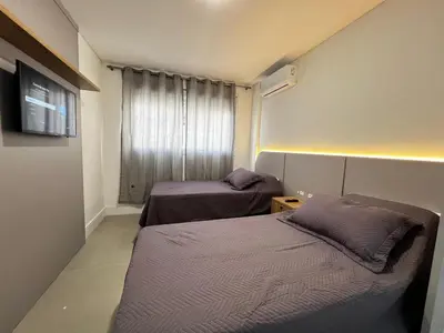 Uma cama ou camas num quarto em Apartamento com área de lazer completo à 100 metros da praia de Mariscal - Bombinhas