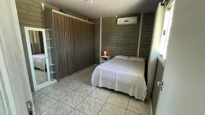 Uma cama ou camas num quarto em Casa de temporada em Bombinhas - SC
