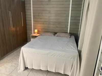 Uma cama ou camas num quarto em Casa de temporada em Bombinhas - SC
