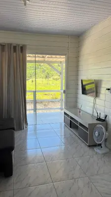 Uma televisão e/ou sistema de entretenimento em Casa de temporada em Bombinhas - SC