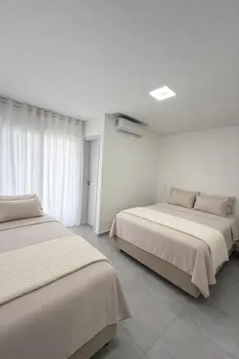 Uma cama ou camas num quarto em MShome, Casa de Praia Completa em Bombinhas