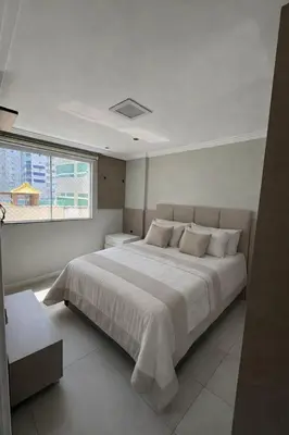 Uma cama ou camas num quarto em Apartamento com 3 quartos no Centro em Balneário Camboriú