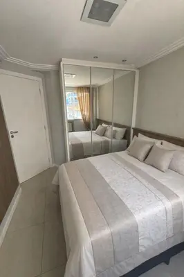 Uma cama ou camas num quarto em Apartamento com 3 quartos no Centro em Balneário Camboriú