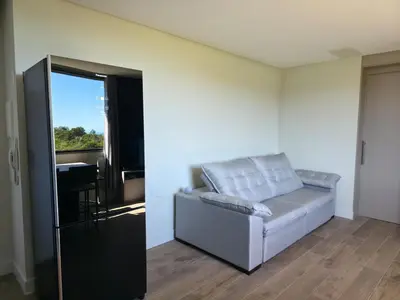 Uma área de estar em Apartamento Vista Mar, com Piscina Aquecida e Jacuzzi