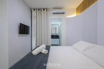 Uma cama ou camas num quarto em Apto c/ 3 suítes, churrasq. e vista mar DEN1301