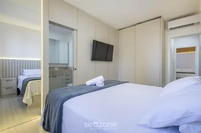 Uma cama ou camas num quarto em Apto c/ 3 suítes, churrasq. e vista mar DEN1301