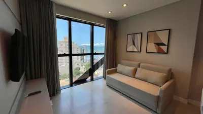 Uma área de estar em Flat com Vista Mar • Conforto e Lazer em Itapema
