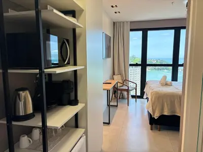 Uma cama ou camas num quarto em Studio com vista mar para até 3 pessoas em Itapema