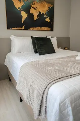 Uma cama ou camas num quarto em Apartamento Luxuoso Beira-Mar - 4 Suítes e Garagem