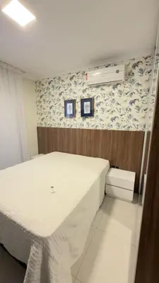 Uma cama ou camas num quarto em PRAIA de BOMBAS AP 303 RESIDENCIAL BREEZE
