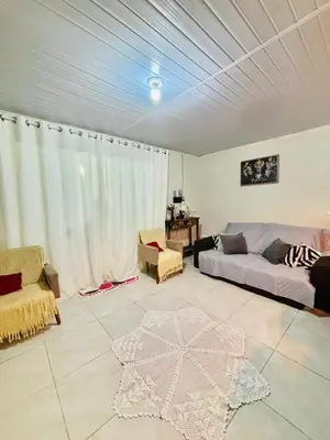 Uma área de estar em Casa com 3 Dormitórios em Zimbros